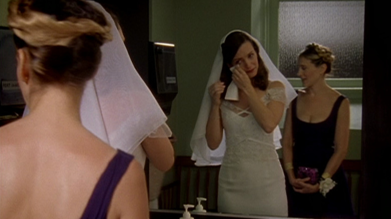 Charlotte York (Kristin Davis) wipes her eye as Carrie Bradshaw (Sarah Jessica Parker) watches in Sex and the City