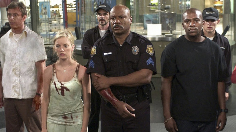 Jake Weber as Michael Shaunessy, Sarah Polley as Ana Clark, Michael Kelly as C.J., Ving Rhames as Sergeant Kenneth Hall, and Mekhi Phifer as Andre standing in a mall in Dawn of the Dead (2004)