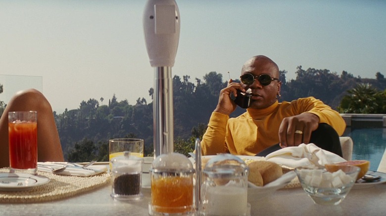 Ving Rhames as Marsellus Wallace talking on his phone at the breakfast table in Pulp Fiction