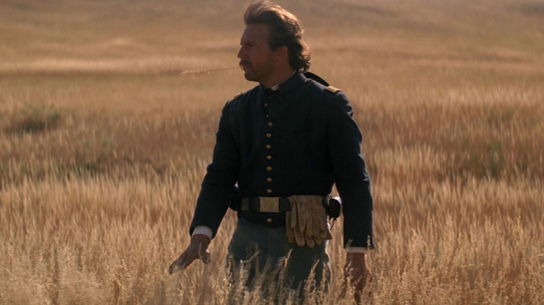 Kevin Costner as John, going outside and touching grass in Dances with Wolves