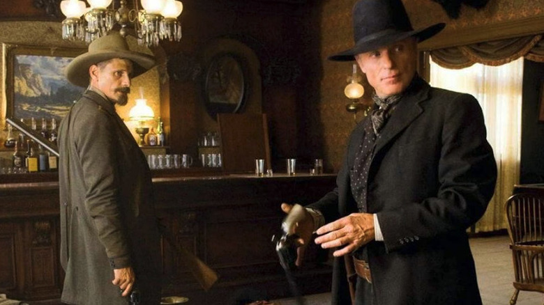 Virgil Cole (Ed Harris) and Viggo Mortensen as Everett Hitch stand in a bar with guns drawn in Appaloosa