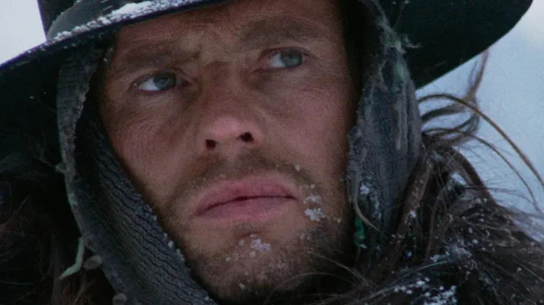 Silence (Jean-Louis Trintignant) glances warily in the snow in The Great Silence