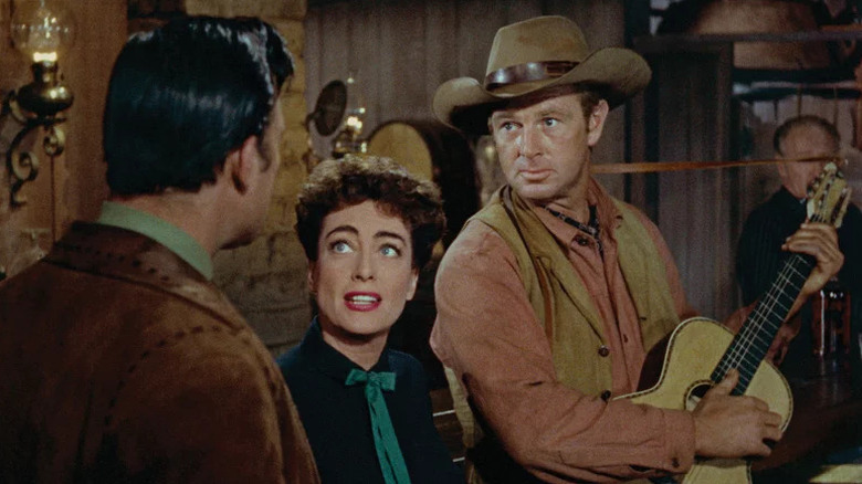 Vienna (Joan Crawford) stands next to Johnny Guitar (Sterling Hayden) in Johnny Guitar