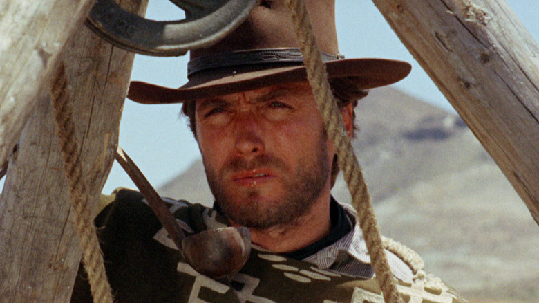 Manco (Clint Eastwood) glances from next to a well in For a Few Dollars More