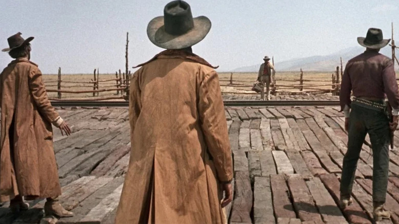 Harmonica (Charles Bronson) faces three gunfighters at a train station in Once Upon a Time in the West