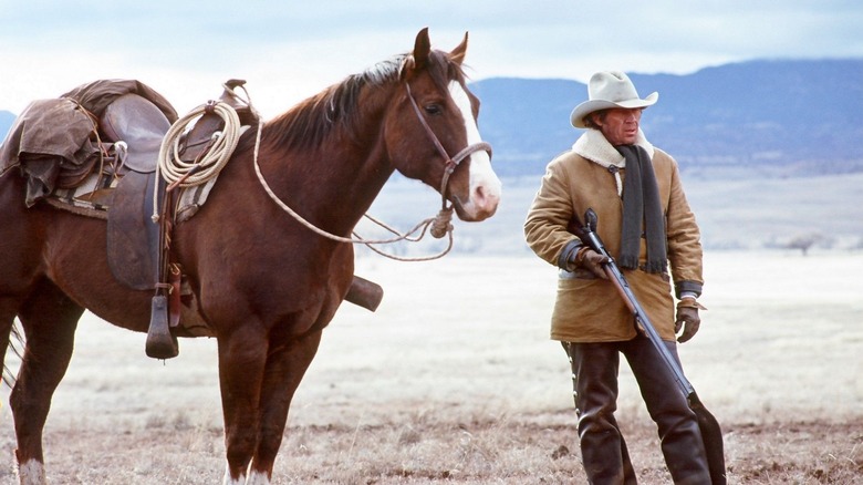 Steve McQueen (right) as Tom Horn, surveying the landscape in Tom Horn