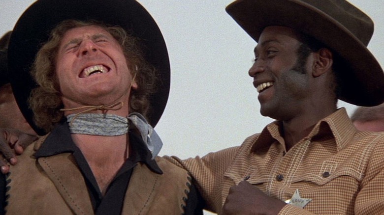 Jim the Waco Kid (Gene Wilder) and Bart (Cleavon Little) laugh together in Blazing Saddles