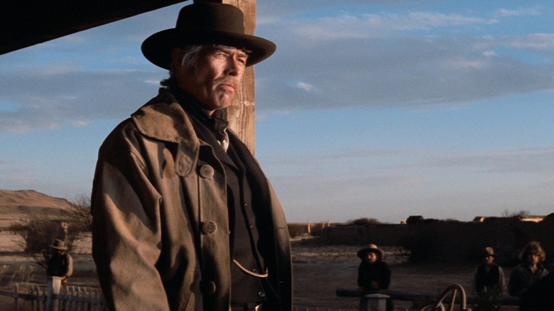 Pat Garrett (James Coburn) looks out pensively from his porch in Pat Garrett and Billy the Kid