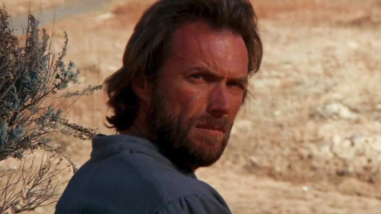 Josey Wales (Clint Eastwood) looks back in a desert in The Outlaw Josey Wales