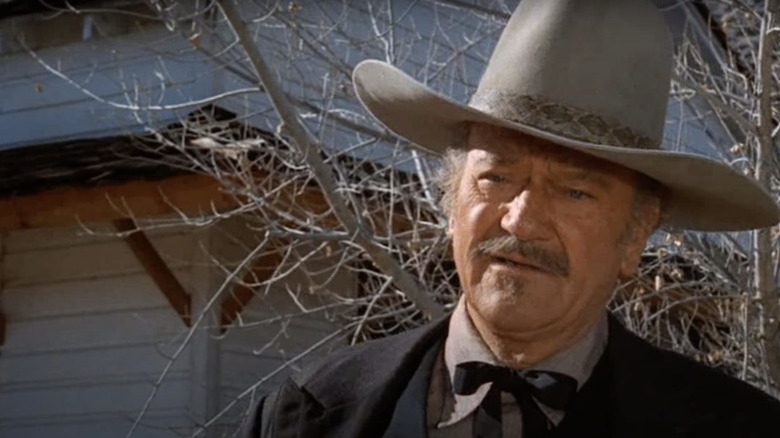 J.B. Books (John Wayne) stands by a barren tree in The Shootist
