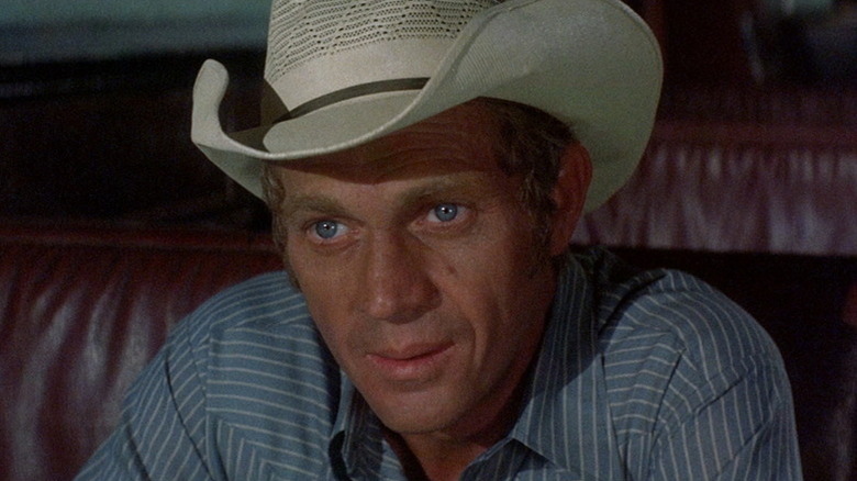 Junior Bonner (Steve McQueen) sits looking up in a booth in Junior Bonner
