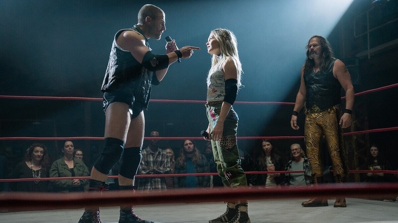 Stephen Amell, Kelli Berglund, and Chris Bauer as Jack Spade, Crystal Tyler, and Wild Bill Hancock cutting an in-ring promo in Heels