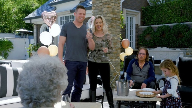 Mike, Maryse, George, and Monroe Mizanin celebrating in the backyard on Miz & Mrs