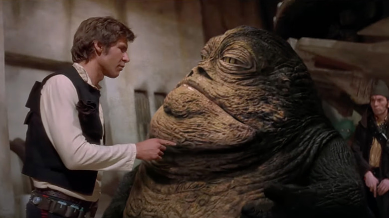 Harrison Ford as Han Solo speaks with Jabba the Hutt in Star Wars