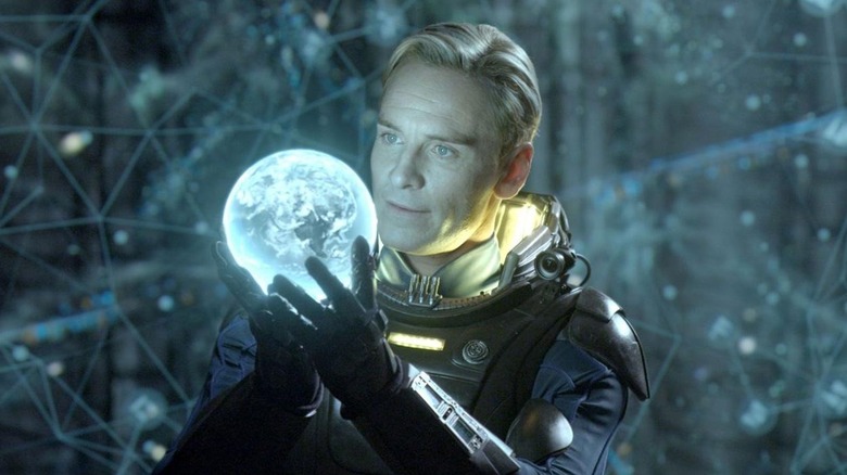 Michael Fassbender as David holds shiny orb in Prometheus
