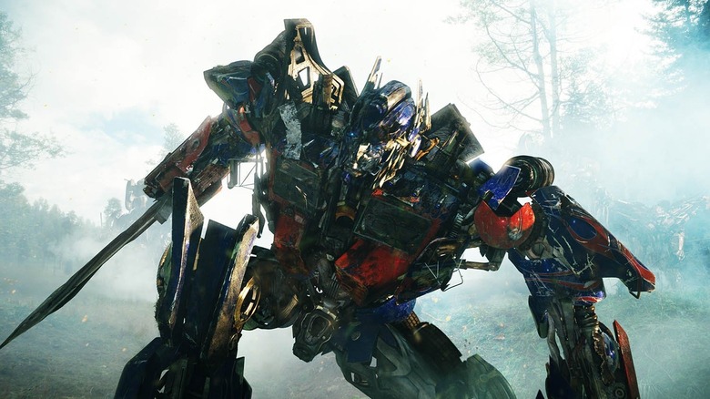 Peter Cullen as Optimus Prime staggers in a forest in Transformers: Revenge of the Fallen