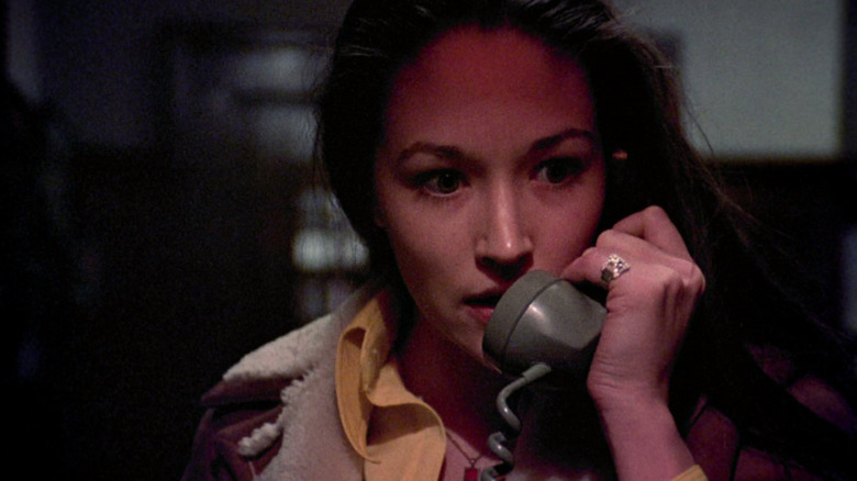Olivia Hussey as Jessica "Jess" Bradford in Black Christmas, looking concerned while talking on the landline.