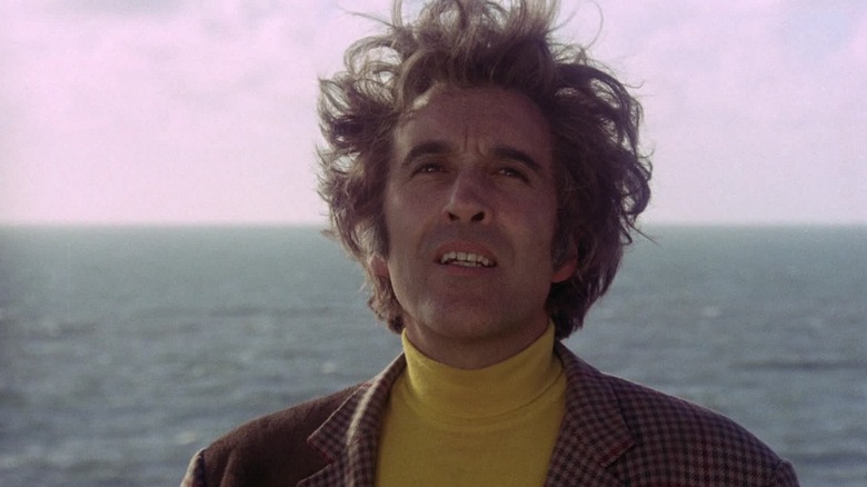 Christopher Lee as Lord Summerisle in The Wicker Man, set against the sea and looking longingly off at something.