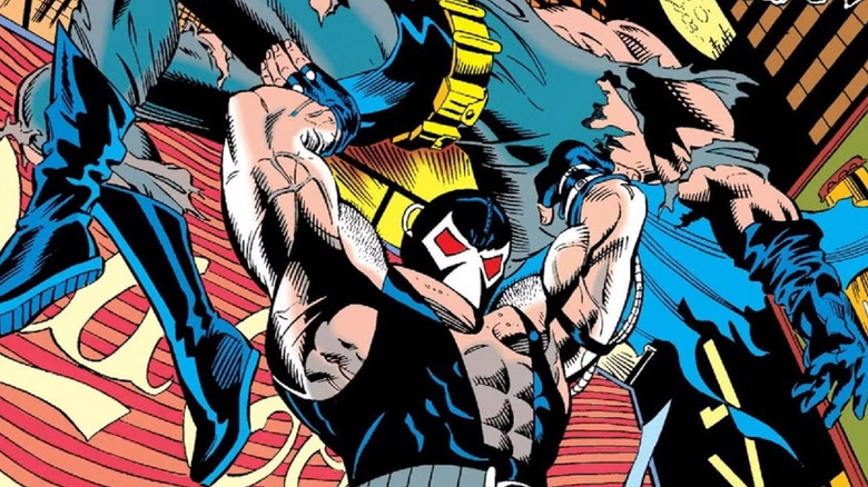 Bane holds Batman over his head