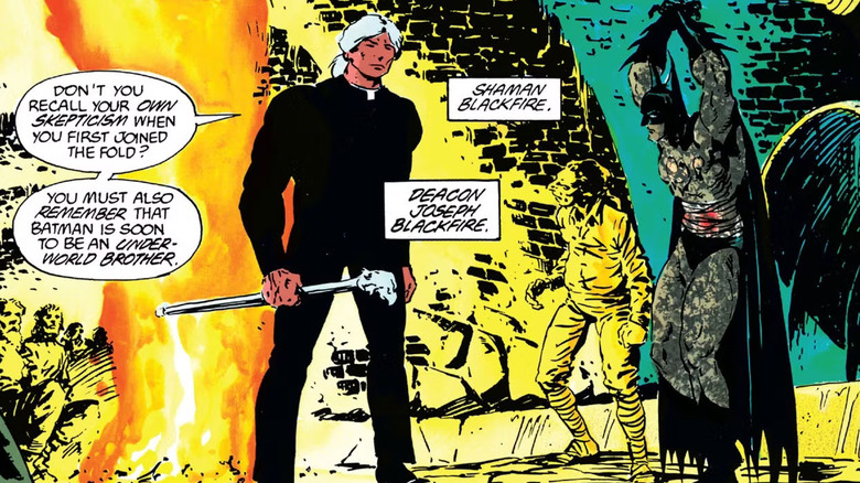 Deacon Blackfire stands in front of a tied up Batman