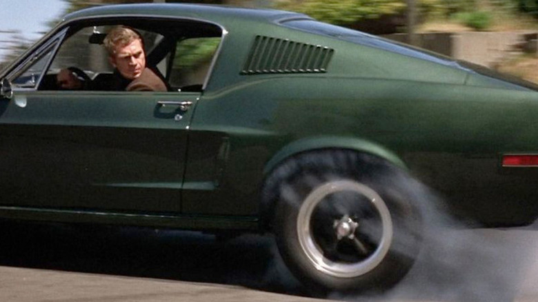 Frank Bullitt (Steve McQueen) looks back while speed in a green Mustang in Bullitt