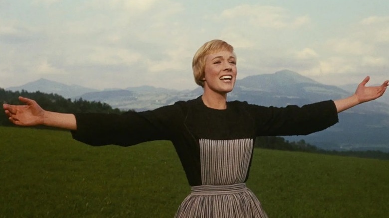 Maria (Julie Andrews) sings across the Alps with outstretched arms in The Sound of Music