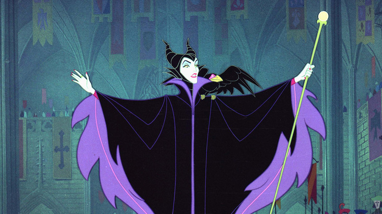 Maleficent (Eleanor Audley) spreads her arms in a royal hall in Sleeping Beauty (1959)