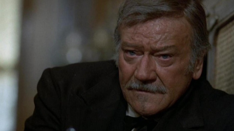 J.B. Books (John Wayne) takes cover in The Shootist