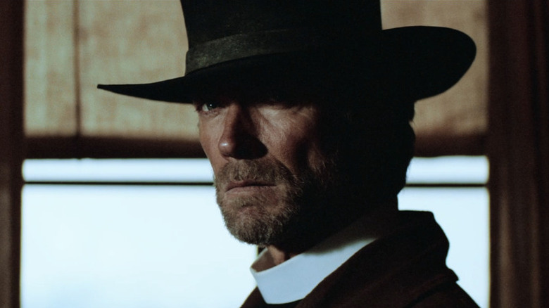 The Preacher (Clint Eastwood) glares while wearing a clerical collar in Pale Rider