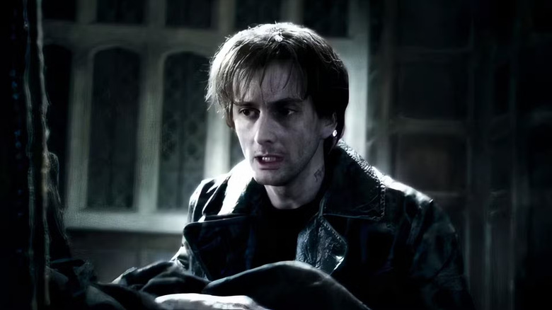 David Tennant as Barty Crouch Jr. in Harry Potter and the Goblet of Fire, looking with concern at something.