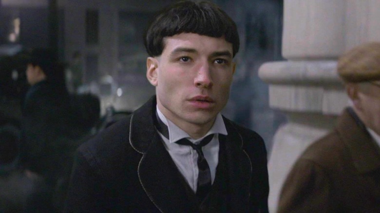 A medium shot of Ezra Miller as Credence Barebone in Fantastic Beasts: The Crimes of Grindelwald, looking off at something.