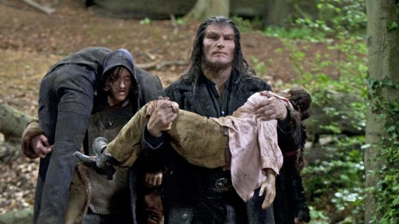Dave Legeno as Fenrir Greyback and Nick Moran as Scabior in Harry Potter and the Deathly Hallows - Part 1, carrying captured victims.