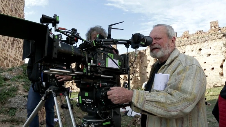 Terry Gilliam looking through camera while filming The Man Who Killed Don Quixote