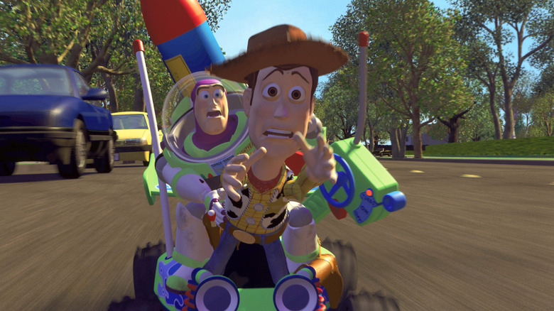 Buzz Lightyear, Woody, and RC try to catch the moving truck in Toy Story