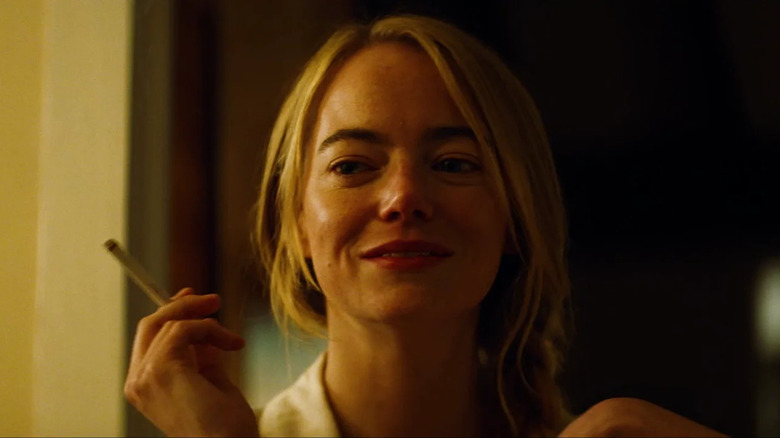 Emma Stone as Liz smoking a cigarette in Kinds of Kindness