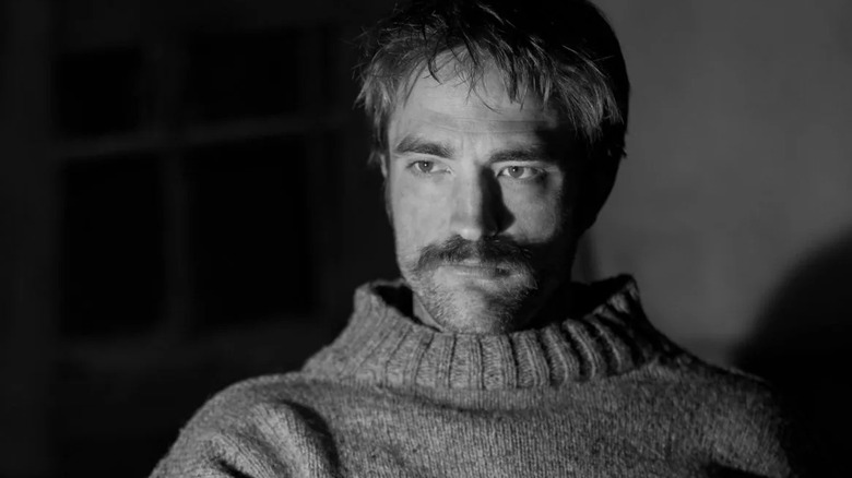 Robert Pattinson as Ephraim Winslow staring in The Lighthouse