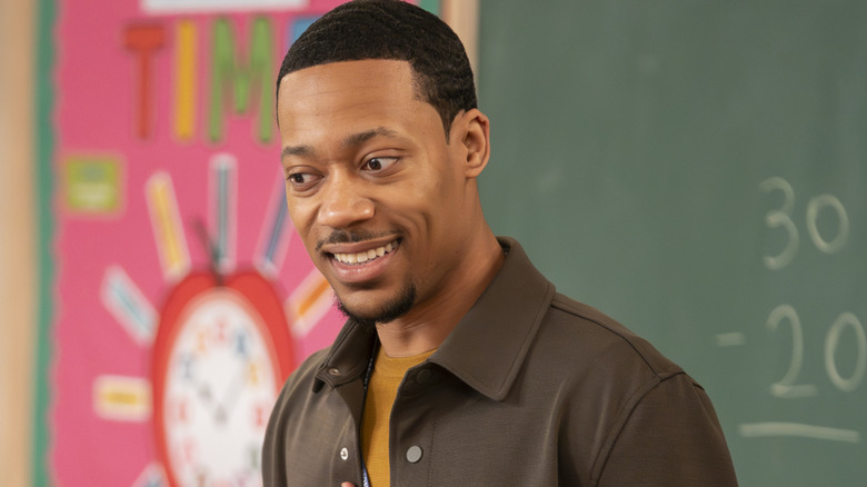 Gregory Eddie (Tyler James Williams) smiling in a classroom on Abbott Elementary