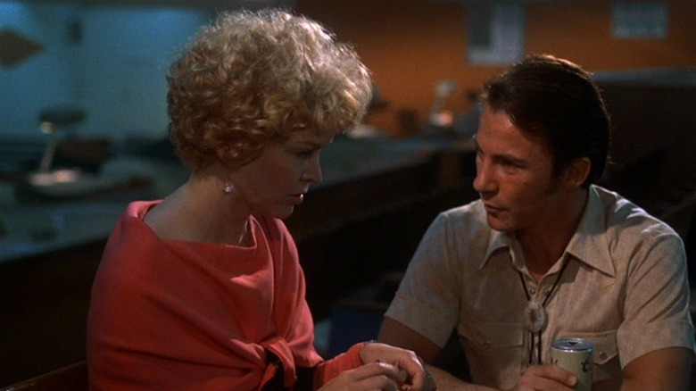 Ellen Burstyn in orange with hair done up  next do Harvey Keitel as Ben in Alice Doesn't Live Here Anymore