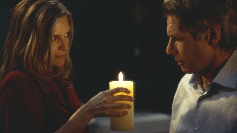 Claire (Michelle Pfeiffer) shares candle with Norman (Harrison Ford) in What Lies Beneath