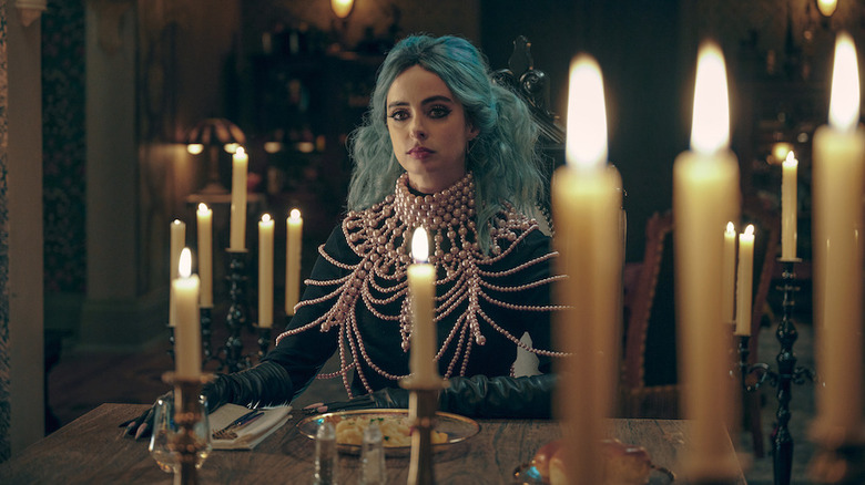 Krysten Ritter plays a witch and is surrounded by candles