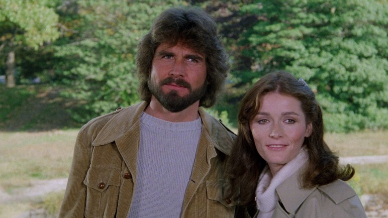 Josh Brolin as George Lutz stands next to Margot Kidder as Kathy Lutz in The Amityville Horror