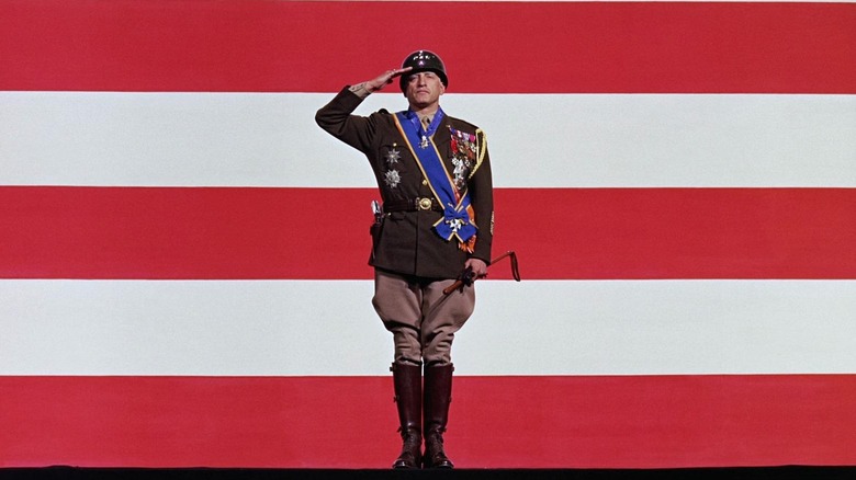 General George S. Patton (George C. Scott) in front of the American flag in Patton