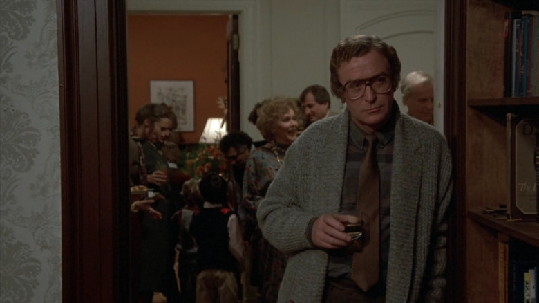 Elliot (Michael Caine) holding a glass in Hannah and Her Sisters