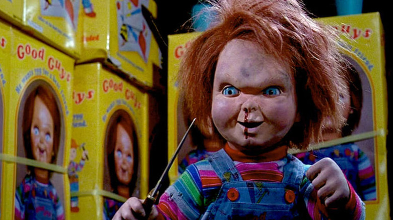 Chucky holds a knife in the Good Guy factory in Child's Play 2