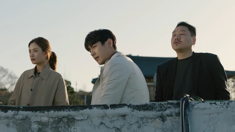 Yeo-rin (Im Jin-ah) and Kang Il-hoon (Park Hae-in) stare over a balcony at sunset in Genesis
