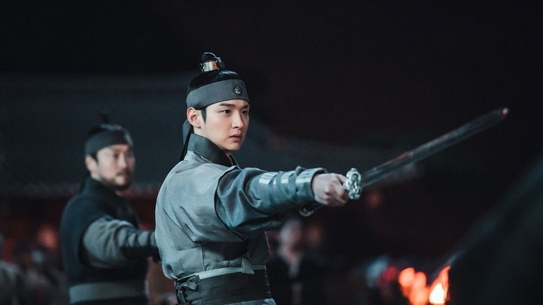 Yangnyeong (Park Sung-hoon) holds at a sword in Joseon Exorcist