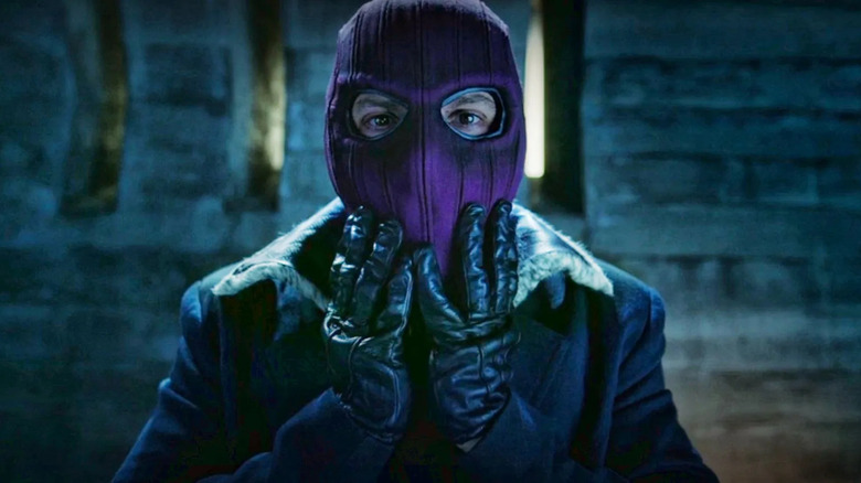 Daniel Bruhl as Baron Zemon touching his mask in The Falcon and the Winter Soldier