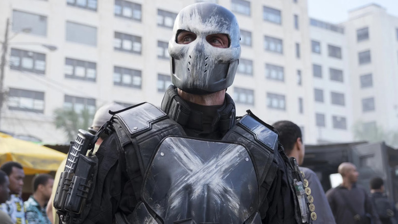 Frank Grillo as Crossbones standing in a market in Captain America: Civil War