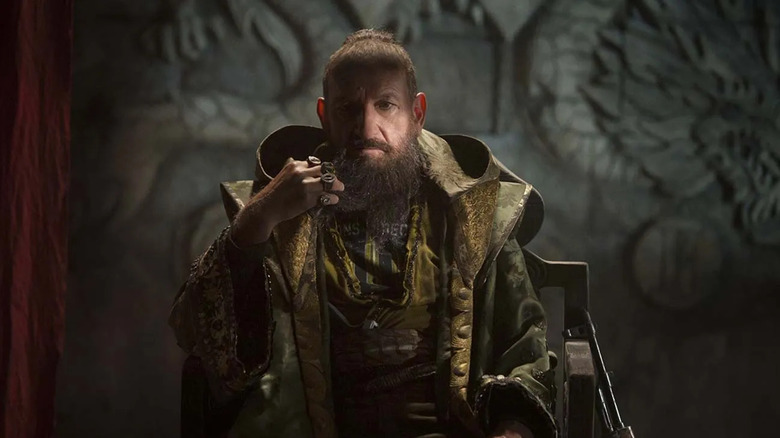 Ben Kingsley as The Mandarin sitting on a throne in Iron Man 3