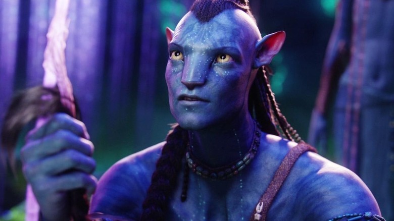 Jake Sully (Sam Worthington) holding his hair braid in Avatar